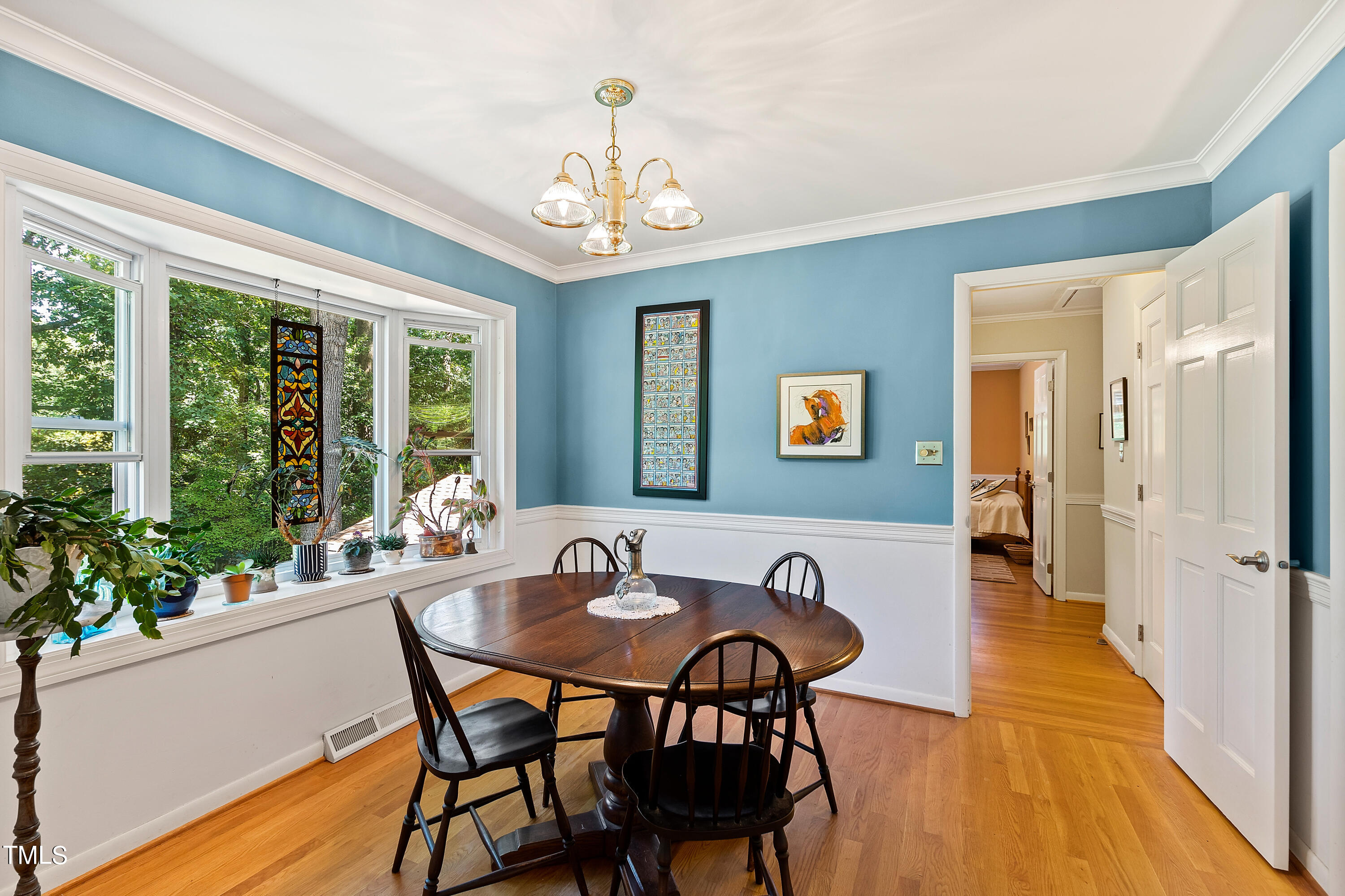 4832 Latimer Road Raleigh, NC 27609 - Photo 16 of 47 a view of a dining room with furniture window and wooden floor