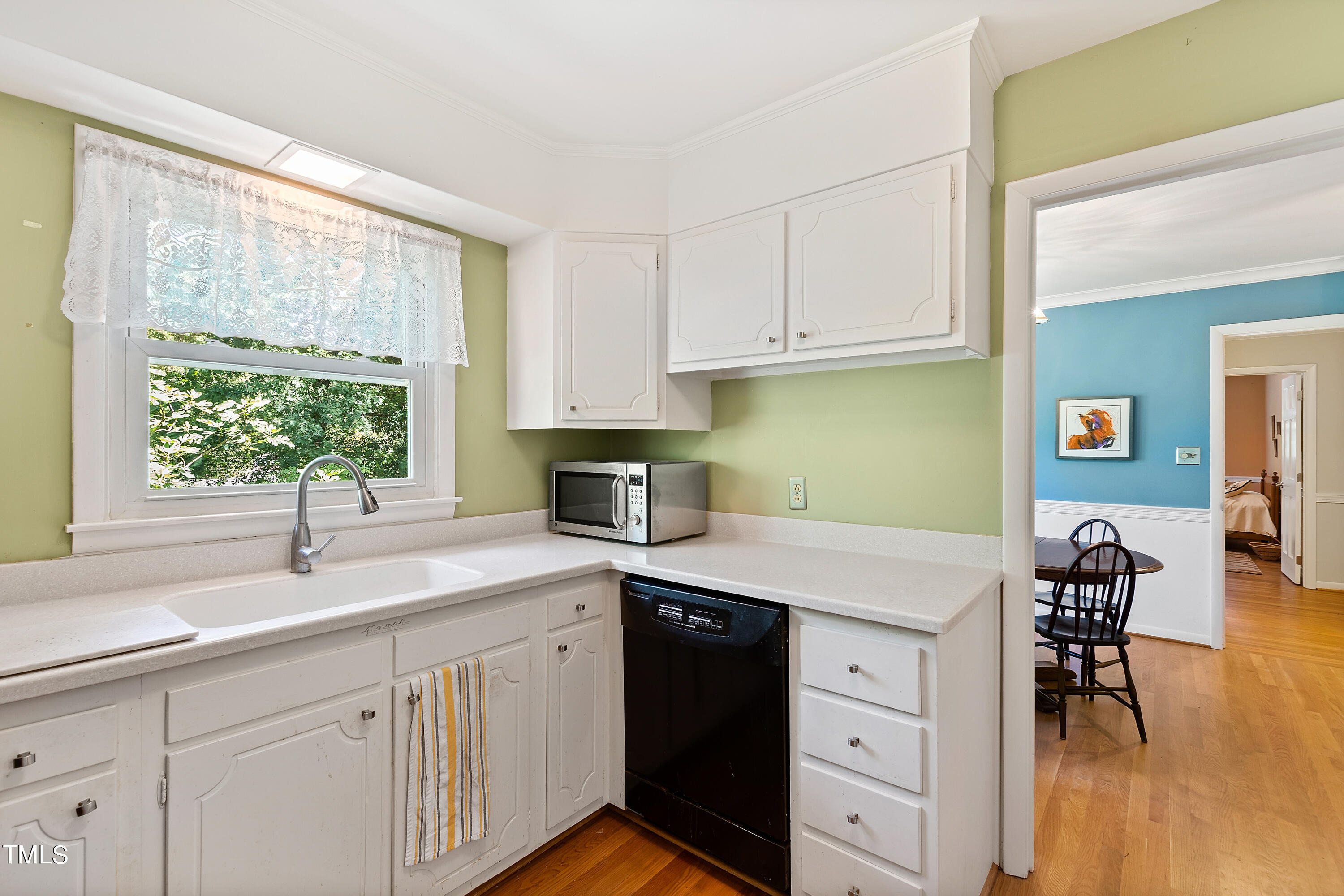 4832 Latimer Road Raleigh, NC 27609 - Photo 17 of 47 a kitchen with a sink window and cabinets