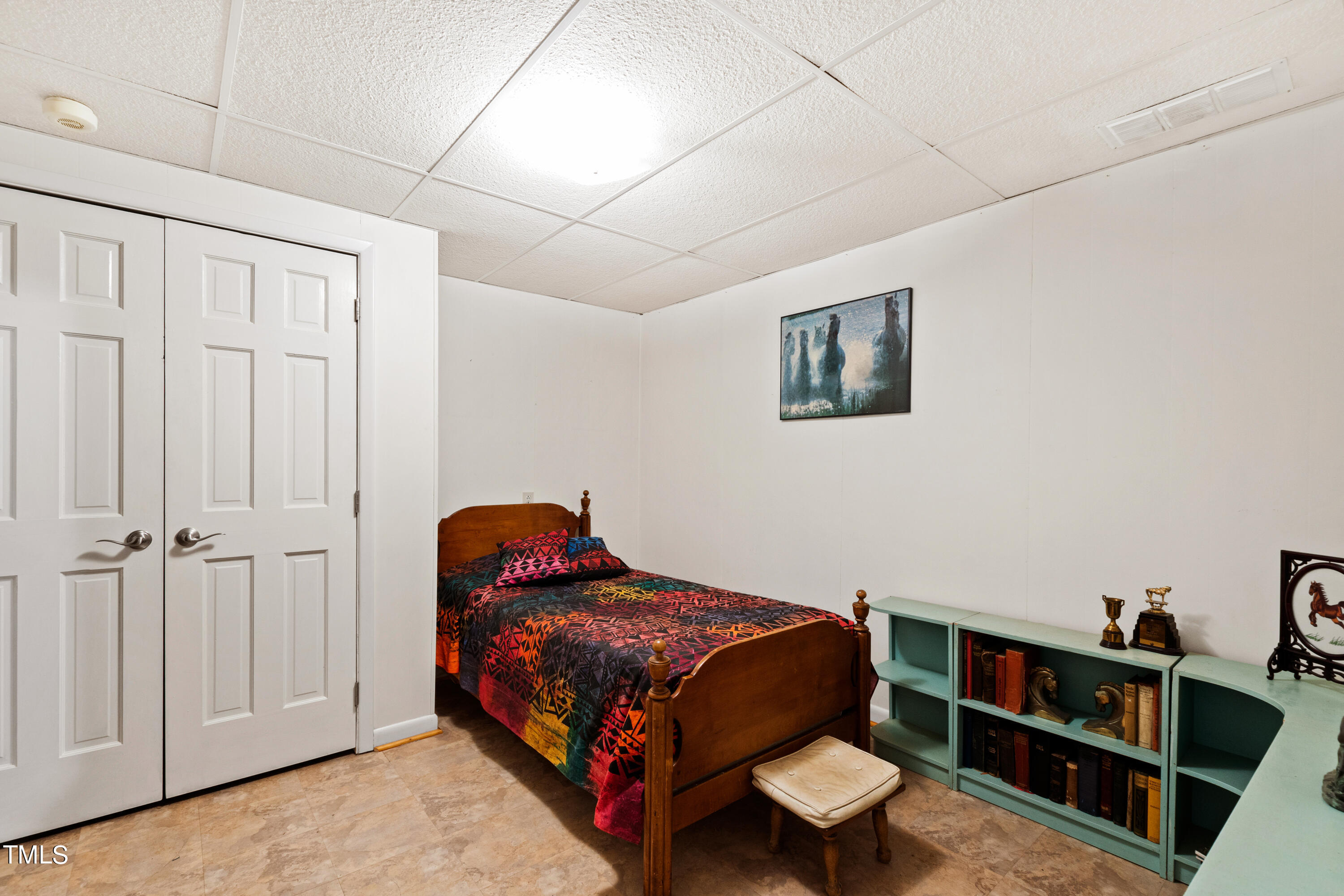4832 Latimer Road Raleigh, NC 27609 - Photo 23 of 47 a bedroom with a bed and a book shelf