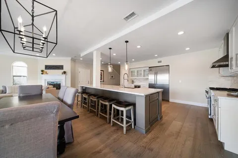 a large kitchen with a table and chairs
