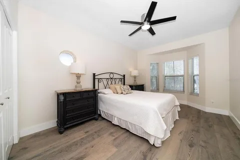a bedroom with a bed and a chandelier