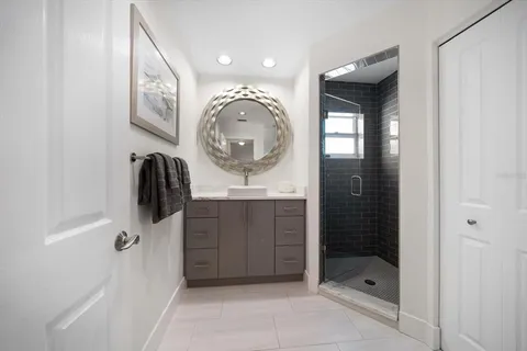 a hallway with a couch and a dining table with wooden floor