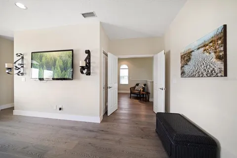 a view of a balcony with wooden floor and outdoor seating