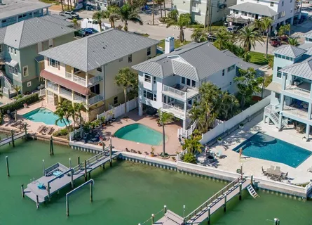 an aerial view of a house with a garden and lake view