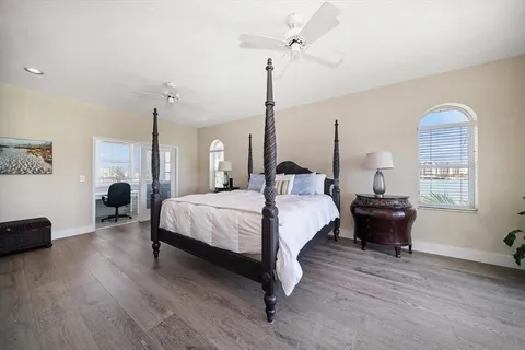 a large white bathroom with a large tub sink shower and mirror
