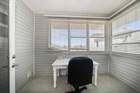 an empty room with furniture and a flat screen tv