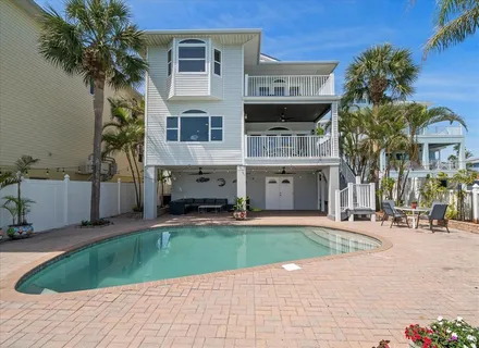a front view of a house with a yard garage and outdoor seating