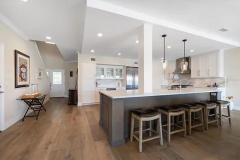 a large kitchen with a table and chairs