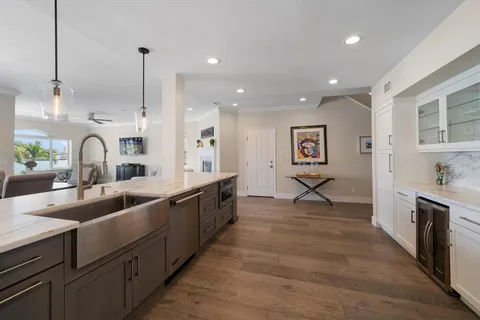 a kitchen with counter top space a sink a refrigerator and cabinets