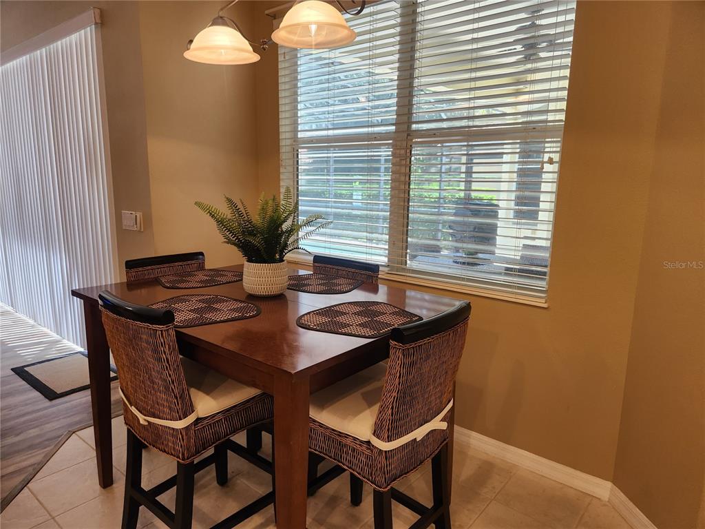 6496 Rookery Circle Bradenton, FL 34203 - Photo 16 of 40 a view of a dining room with furniture and window