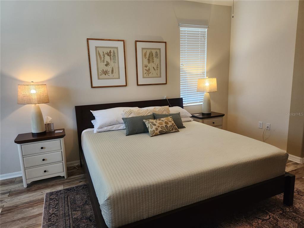 6496 Rookery Circle Bradenton, FL 34203 - Photo 17 of 40 a bedroom with a bed and painting on the wall