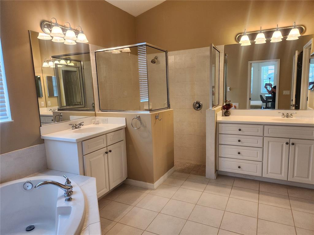 6496 Rookery Circle Bradenton, FL 34203 - Photo 20 of 40 a bathroom with a sink double vanity and a shower