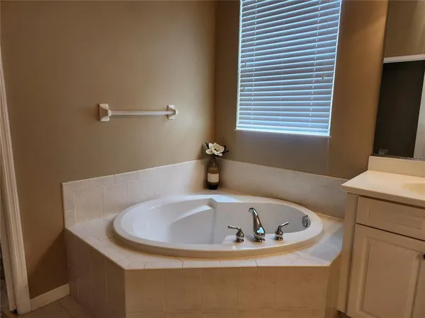 a bathroom with a tub and sink