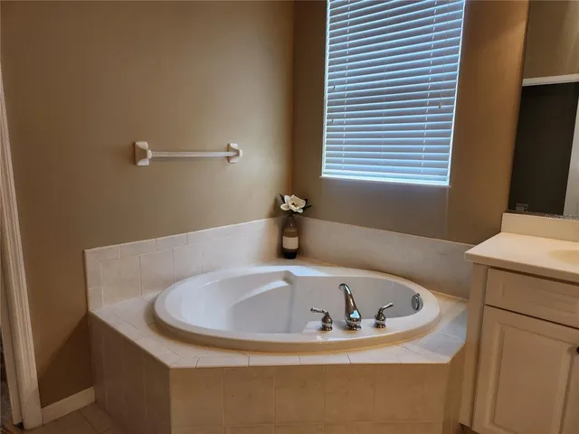 a bathroom with a tub and sink