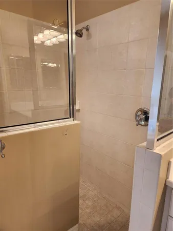 a bathroom with a glass shower door