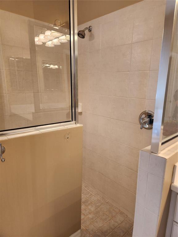 6496 Rookery Circle Bradenton, FL 34203 - Photo 22 of 40 a bathroom with a glass shower door