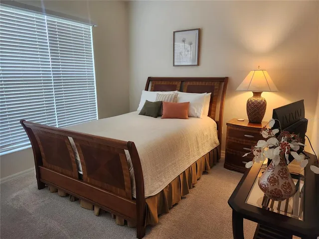 a bedroom with bed and window