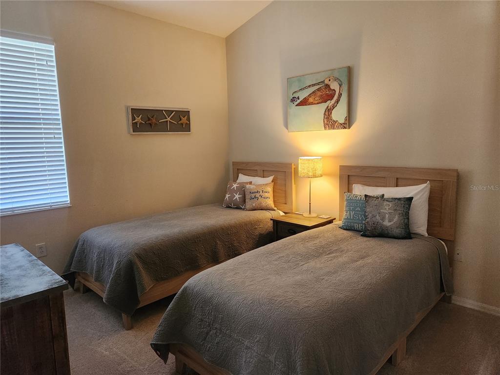 6496 Rookery Circle Bradenton, FL 34203 - Photo 28 of 40 a bedroom with two beds and a window