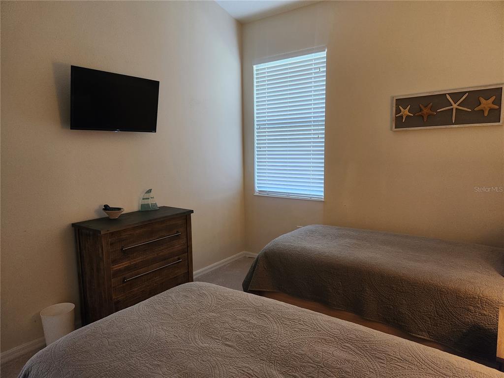 6496 Rookery Circle Bradenton, FL 34203 - Photo 29 of 40 a bedroom with a bed and a flat screen tv