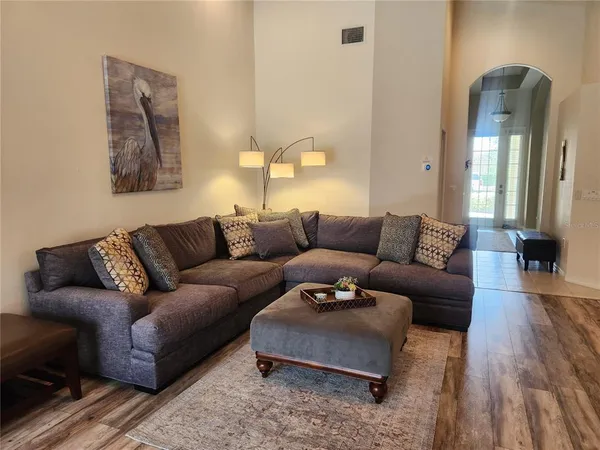 a living room with furniture and a lamp