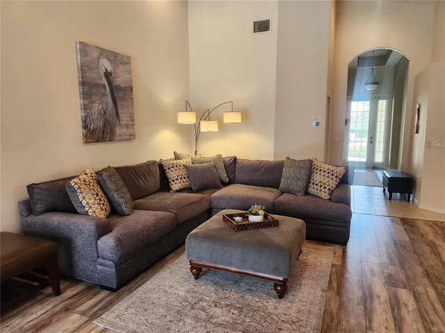 a living room with furniture and a lamp