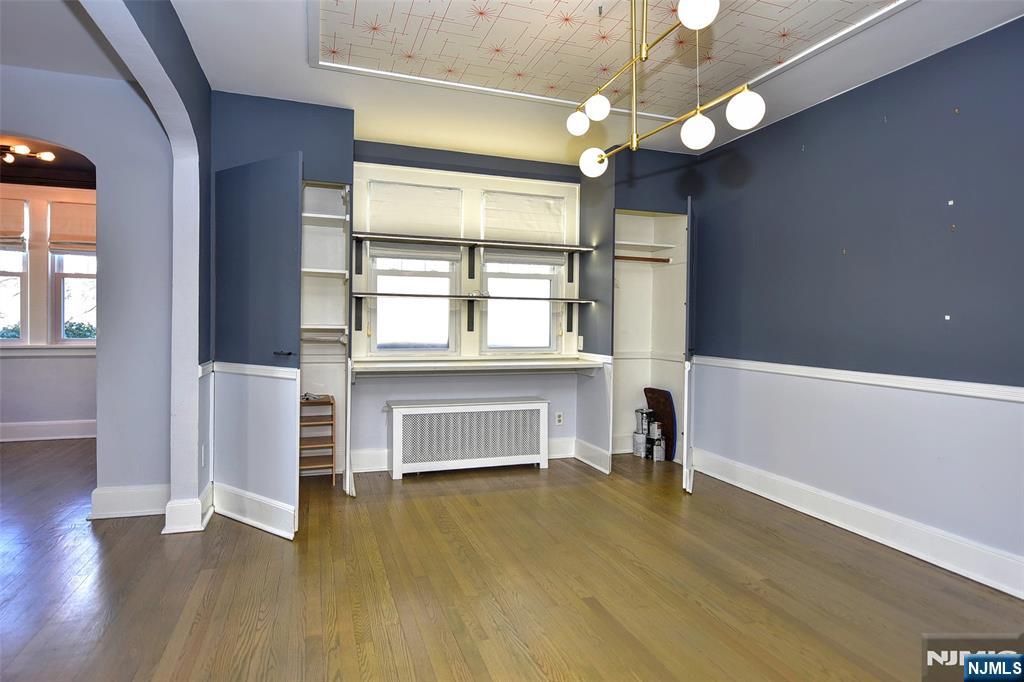 12-64 Burbank Street Fair Lawn, NJ 07410 - Photo 12 of 34 wooden floor in an empty room with a window