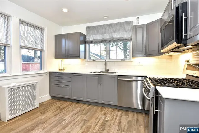 a kitchen with stainless steel appliances granite countertop a sink and a stove