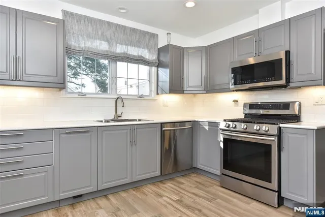 a kitchen with stainless steel appliances a refrigerator stove and microwave