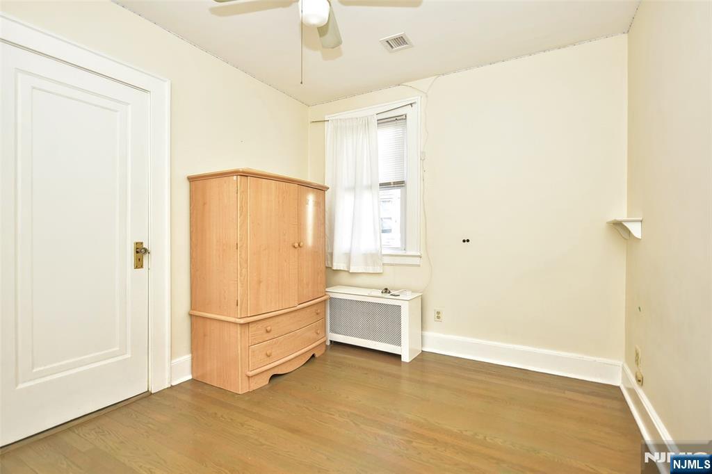 12-64 Burbank Street Fair Lawn, NJ 07410 - Photo 17 of 34 a view of an empty room with window and a refrigerator