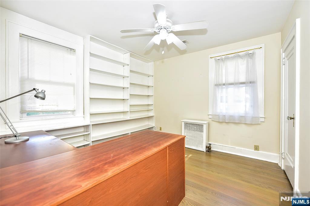 12-64 Burbank Street Fair Lawn, NJ 07410 - Photo 18 of 34 a view of a room with wooden floor and ceiling fan