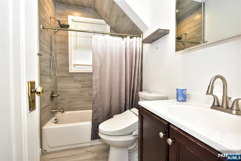 12-64 Burbank Street Fair Lawn, NJ 07410 - Photo 20 of 34 a bathroom with a sink a toilet and a bathtub