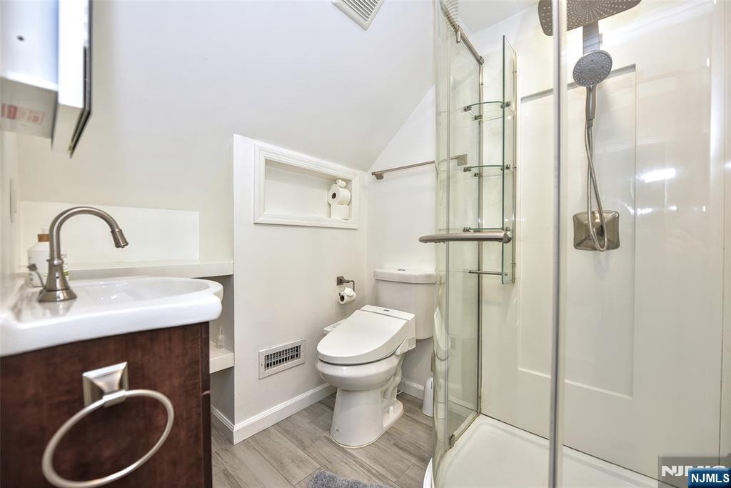 12-64 Burbank Street Fair Lawn, NJ 07410 - Photo 23 of 34 a bathroom with a toilet sink and mirror