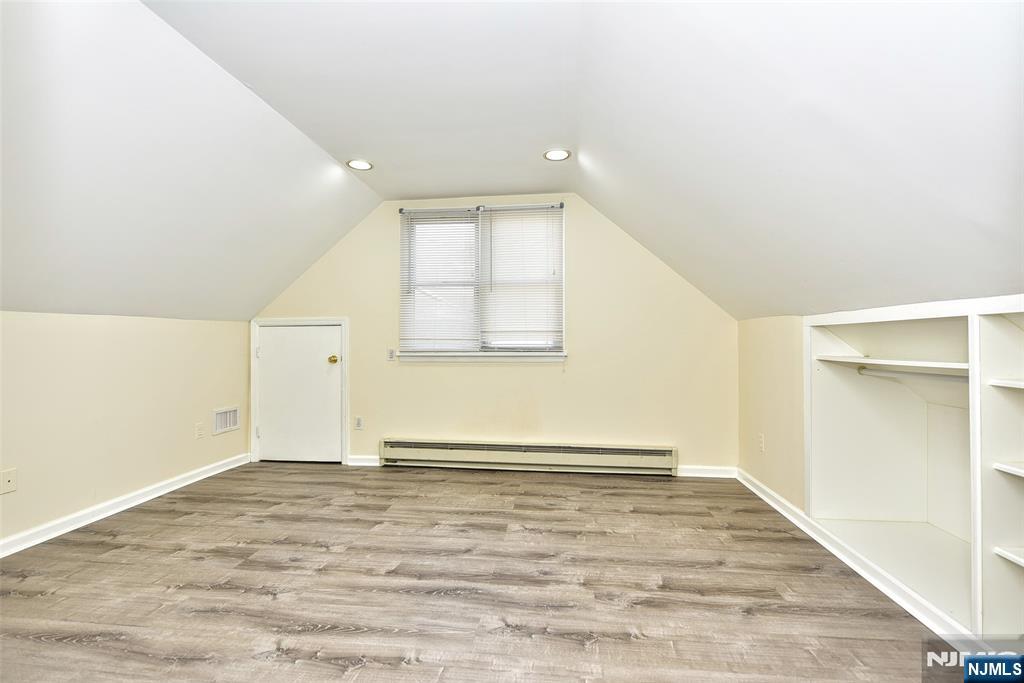 12-64 Burbank Street Fair Lawn, NJ 07410 - Photo 24 of 34 an empty room with wooden floor and windows