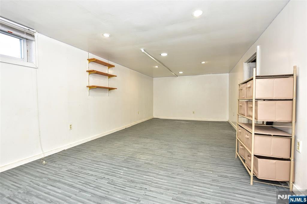 12-64 Burbank Street Fair Lawn, NJ 07410 - Photo 26 of 34 a view of an empty room with wooden floor and a window