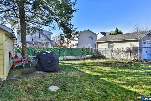 a view of a backyard with a large tree