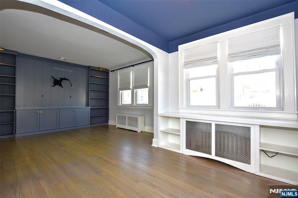 12-64 Burbank Street Fair Lawn, NJ 07410 - Photo 5 of 34 an empty room with wooden floor and windows