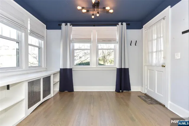 a view of a room with wooden floor and cabinet