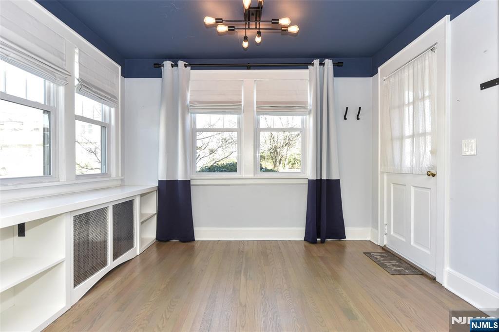 12-64 Burbank Street Fair Lawn, NJ 07410 - Photo 6 of 34 a view of an empty room with a window and wooden floor