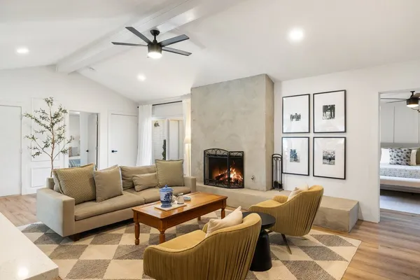 a living room with furniture and a fireplace