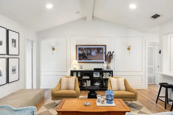 a living room with furniture and wooden floor