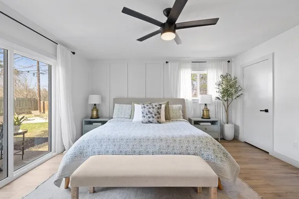 a bedroom with a large bed and a chandelier