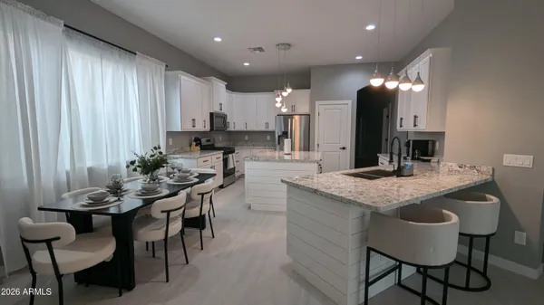 a kitchen with center island table and chairs in it