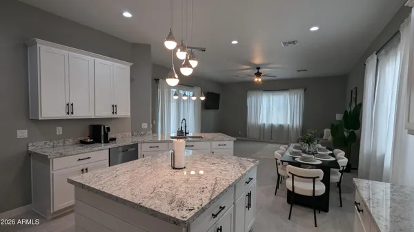 a kitchen with a sink refrigerator and cabinets