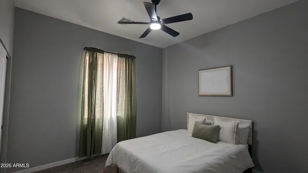 a view of bedroom with furniture and a window