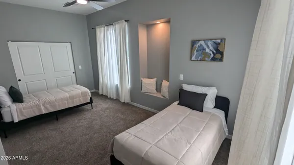 a bedroom with a bed and a painting on the wall