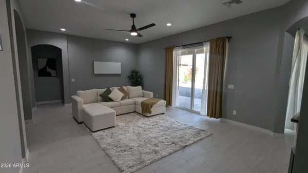 a living room with furniture and a chandelier