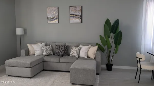 a living room with furniture and a potted plant