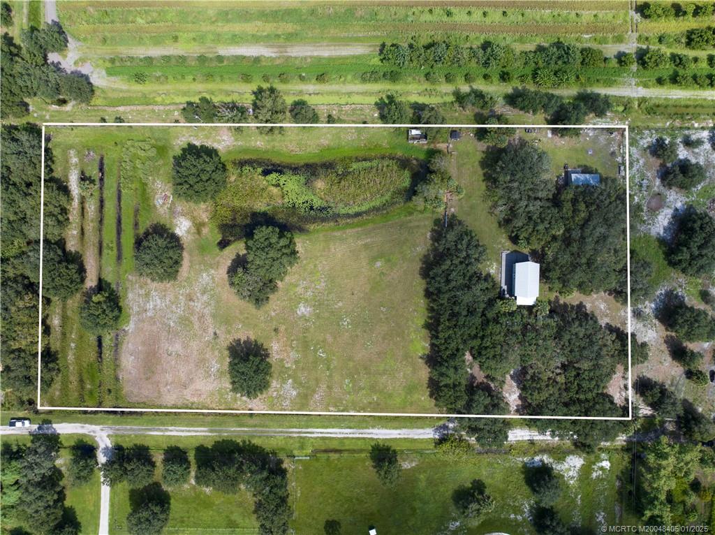 11809 Southwest Fox Brown Road Indiantown, FL 34956 - Photo 2 of 7 an aerial view of residential houses with outdoor space and lake view