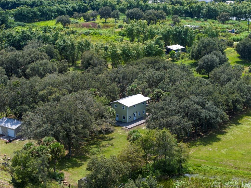 11809 Southwest Fox Brown Road Indiantown, FL 34956 - Photo 5 of 7 a aerial view of a house with a yard and lake view