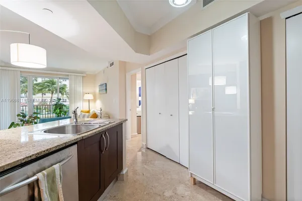a kitchen with granite countertop a sink and a counter top space